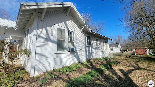 607 N Walnut St, Clarksville, TX 75426 - view of home's exterior with cooling unit and metal roof