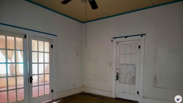 607 N Walnut St, Clarksville, TX 75426 - empty room featuring a ceiling fan, french doors, and healthy amount of natural light