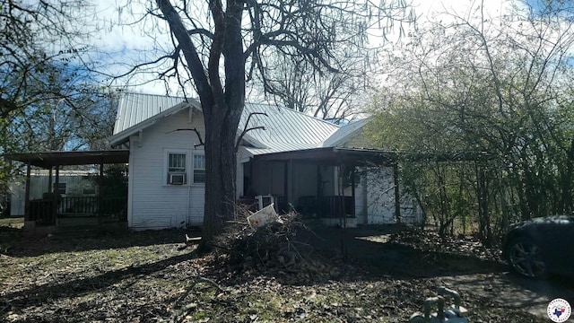 607 N Walnut St, Clarksville, TX 75426 - view of home's exterior with metal roof and a porch