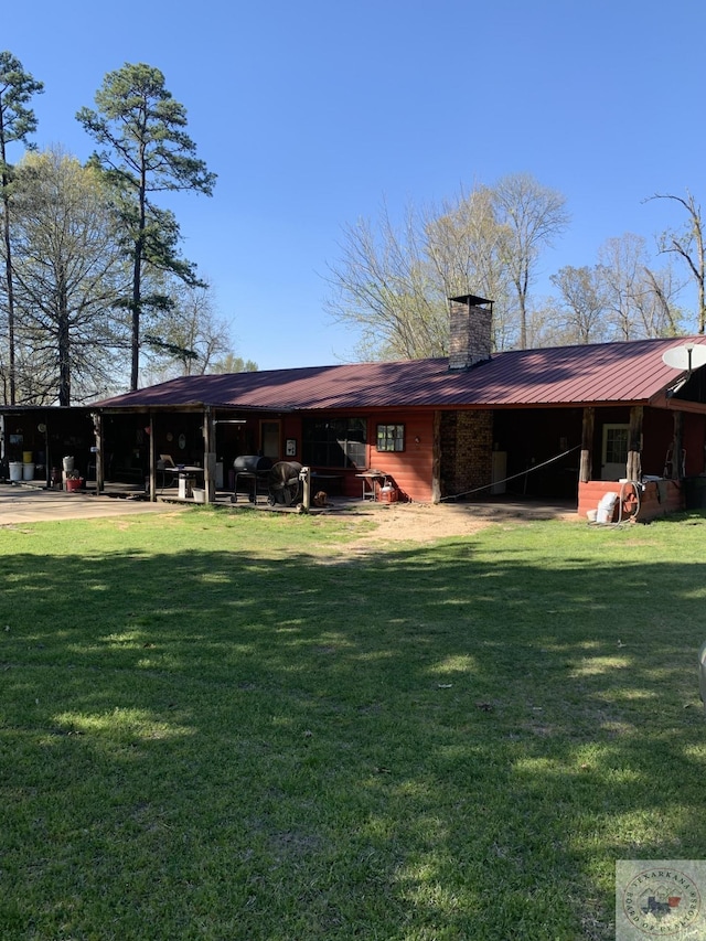 rear view of property featuring a yard