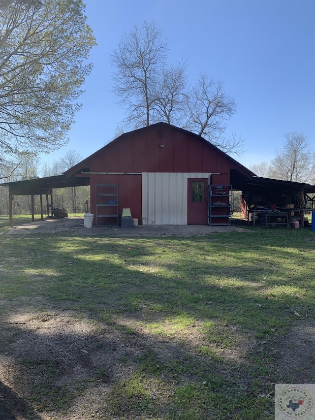 view of outdoor structure featuring a lawn