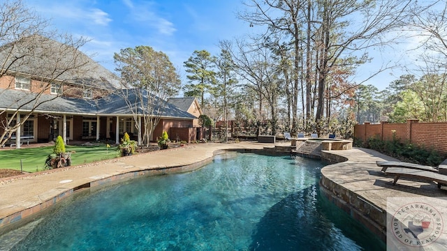 view of swimming pool with a patio, a yard, a fenced backyard, and a pool with connected hot tub