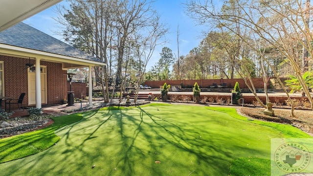 view of yard featuring fence and a patio