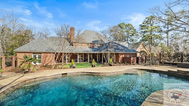 pool featuring fence and a patio