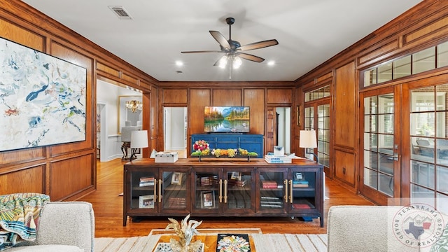 dining space with a ceiling fan, visible vents, ornamental molding, and light wood finished floors