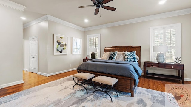 bedroom with baseboards, ceiling fan, wood finished floors, crown molding, and recessed lighting