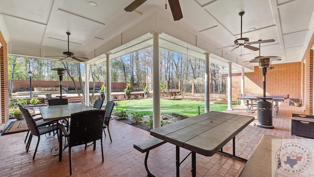 sunroom with a ceiling fan