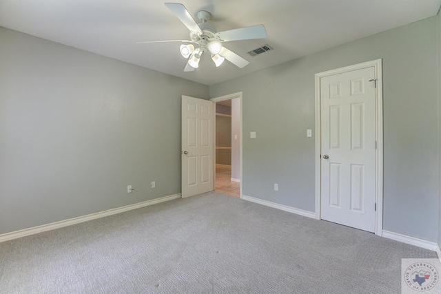 unfurnished bedroom featuring ceiling fan and light colored carpet