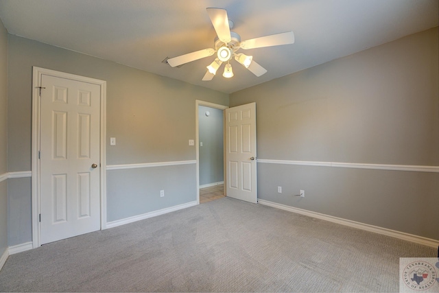 unfurnished room featuring ceiling fan and light colored carpet