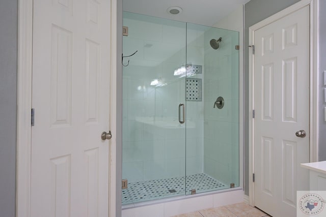 bathroom featuring walk in shower and tile patterned floors