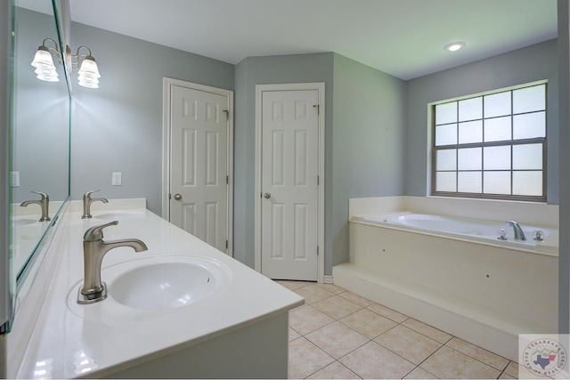 bathroom with tile patterned floors, vanity, and a bath