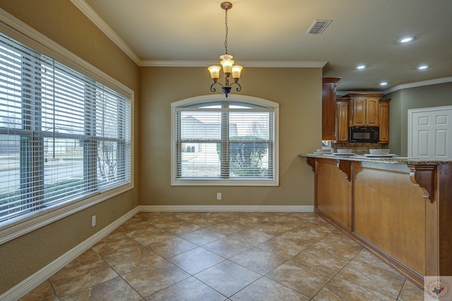 kitchen featuring pendant lighting, a wealth of natural light, ornamental molding, and an inviting chandelier