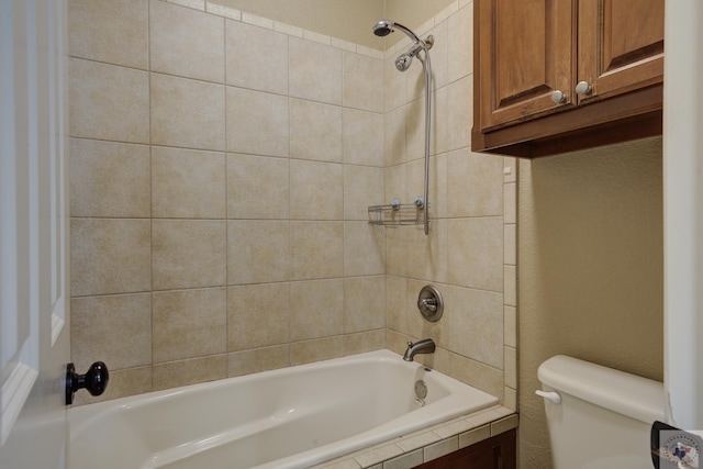 full bathroom with toilet, shower / bath combination, and a textured wall