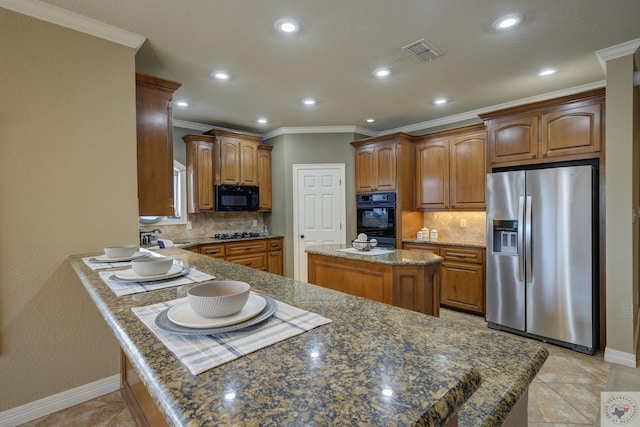 kitchen with visible vents, backsplash, ornamental molding, black microwave, and stainless steel fridge with ice dispenser