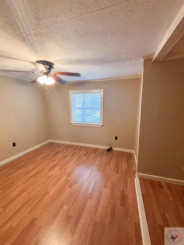 unfurnished room featuring hardwood / wood-style flooring, a textured ceiling, and ceiling fan