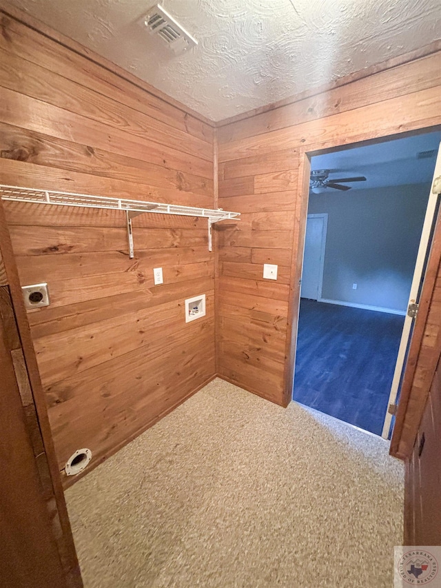 laundry area featuring wooden walls, carpet flooring, and washer hookup