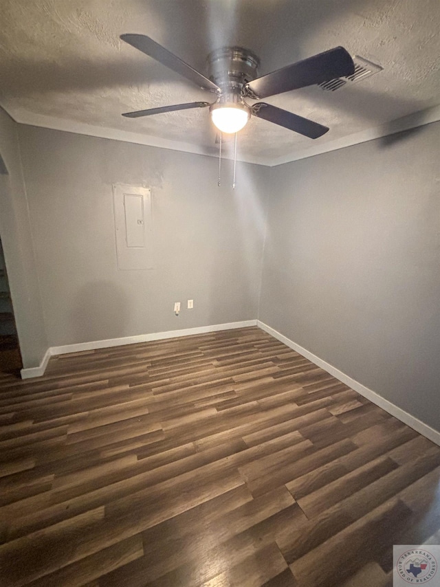 spare room with ceiling fan, dark hardwood / wood-style floors, and a textured ceiling