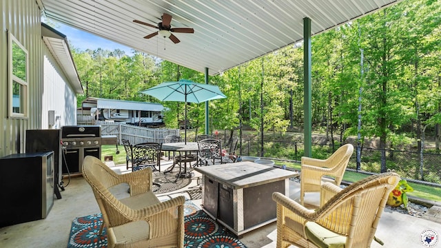 view of patio with outdoor dining space, a grill, a ceiling fan, and an outdoor living space with a fire pit