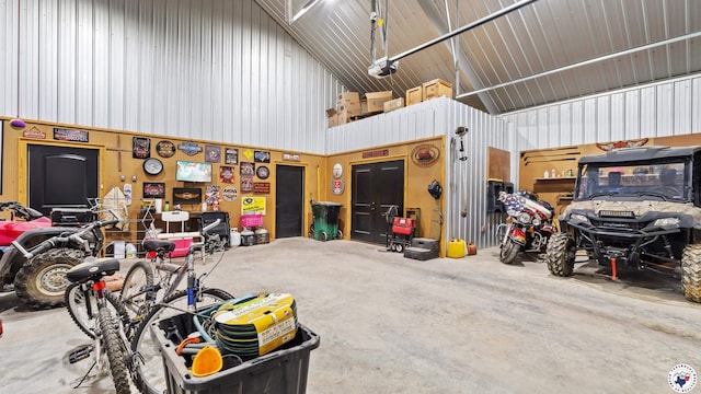 garage with a garage door opener and metal wall