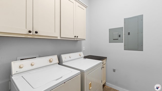 laundry area with electric panel, baseboards, washing machine and clothes dryer, and cabinet space