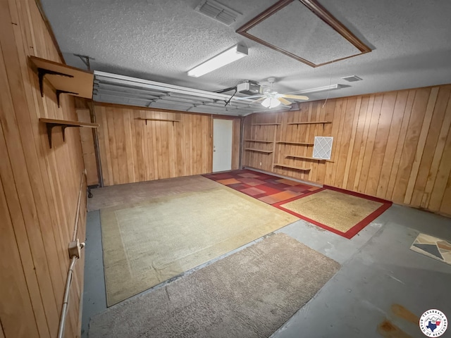 307 Kimball Cir, Wake Village, TX 75501 - garage with wooden walls, a garage door opener, and a ceiling fan
