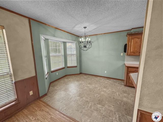 307 Kimball Cir, Wake Village, TX 75501 - unfurnished dining area with crown molding, a chandelier, a textured ceiling, and baseboards