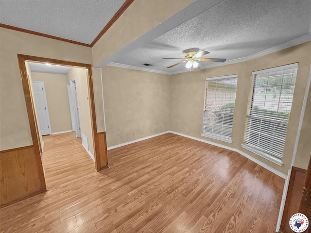307 Kimball Cir, Wake Village, TX 75501 - empty room with a textured ceiling, light wood-style flooring, a ceiling fan, crown molding, and baseboards