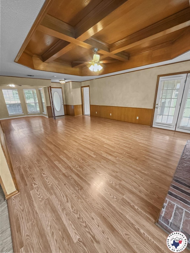 307 Kimball Cir, Wake Village, TX 75501 - unfurnished living room featuring a wainscoted wall, wood finished floors, ceiling fan, coffered ceiling, and beamed ceiling