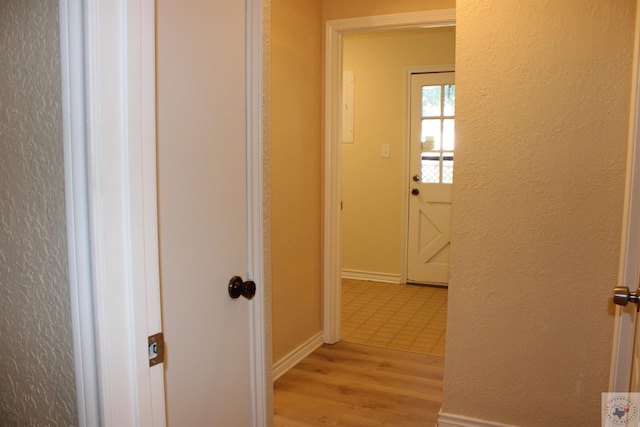 hallway with light hardwood / wood-style flooring