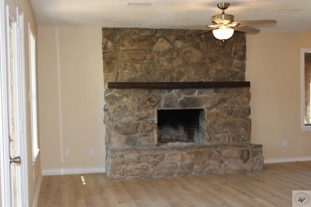 interior space with hardwood / wood-style floors, a fireplace, and a textured ceiling