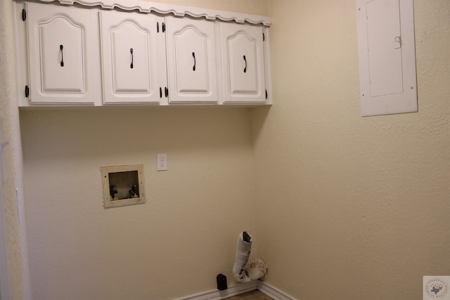 laundry area with hookup for a washing machine, electric panel, and cabinets