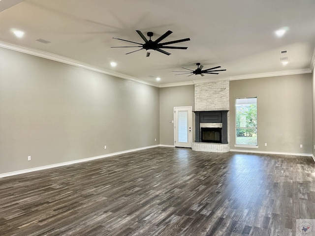 unfurnished living room featuring dark wood-type flooring, a large fireplace, and ornamental molding