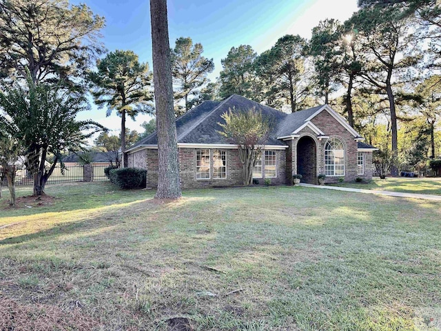 ranch-style home featuring a front yard