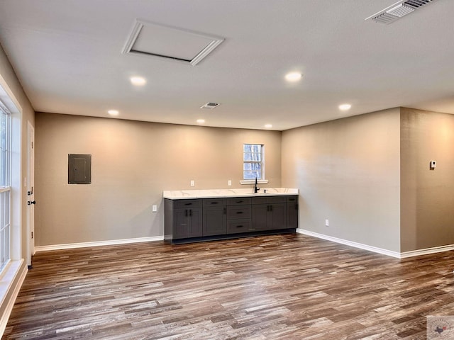 interior space with sink, gray cabinets, electric panel, and dark hardwood / wood-style floors