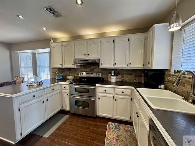 kitchen with visible vents, under cabinet range hood, a sink, stainless steel appliances, and a peninsula