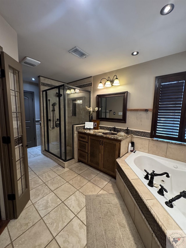 full bathroom featuring vanity, a tub with jets, visible vents, a stall shower, and tile patterned floors