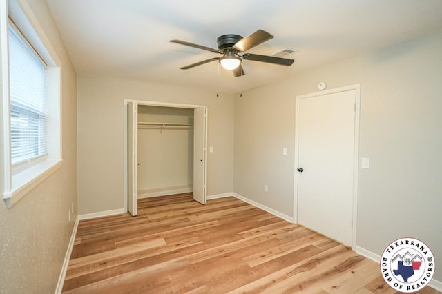 unfurnished bedroom with light wood-style flooring, a ceiling fan, baseboards, visible vents, and a closet