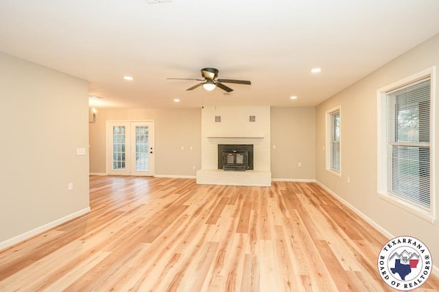 unfurnished living room with baseboards, ceiling fan, light wood-type flooring, and recessed lighting