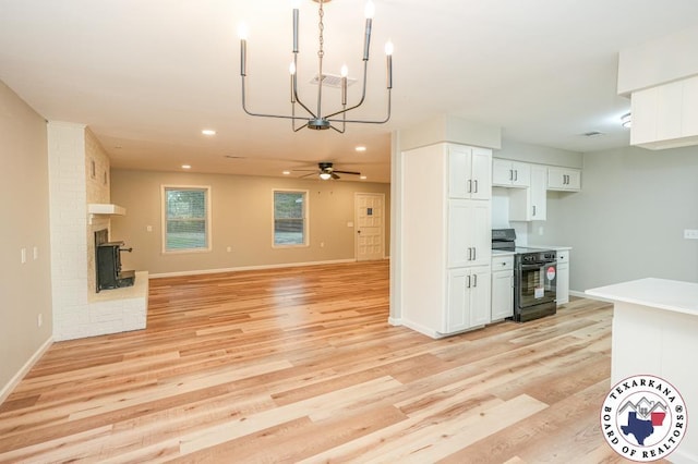 kitchen featuring white cabinets, recessed lighting, light wood-style flooring, and black range with electric cooktop