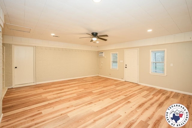 interior space featuring light wood-type flooring, a ceiling fan, brick wall, and recessed lighting