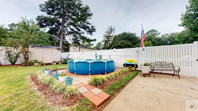 view of patio / terrace with a shed and a fenced in pool