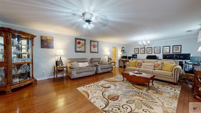 living room with a notable chandelier, crown molding, and hardwood / wood-style floors