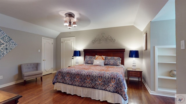 bedroom with hardwood / wood-style flooring, ceiling fan, and lofted ceiling