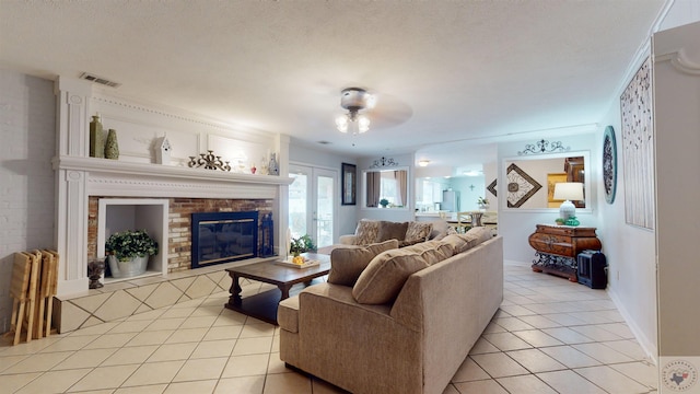 living room featuring light tile patterned floors, a textured ceiling, and a fireplace