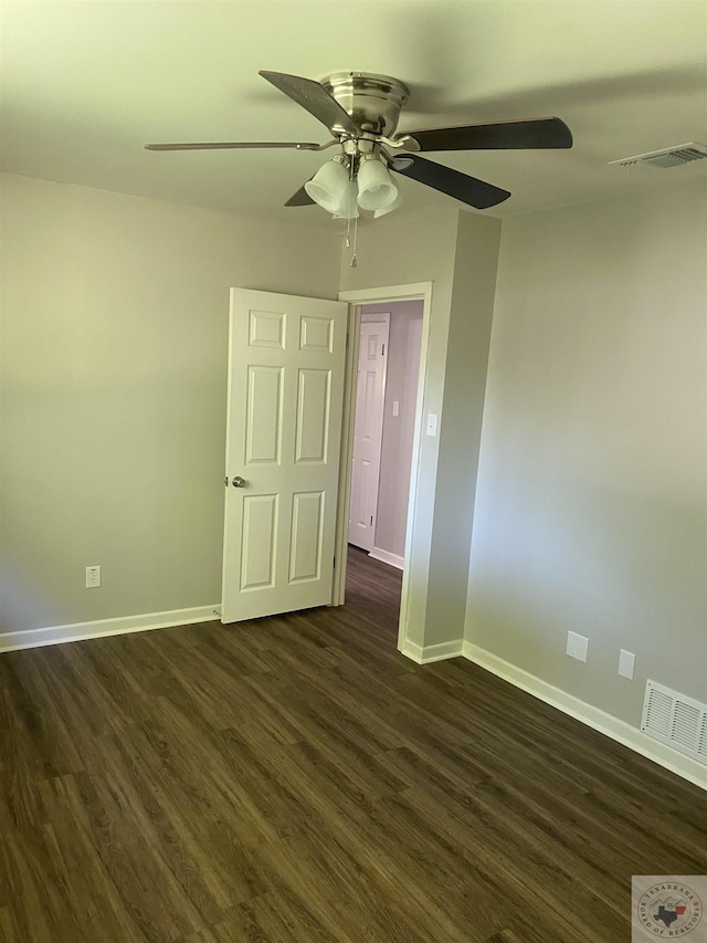 spare room with ceiling fan and dark hardwood / wood-style flooring