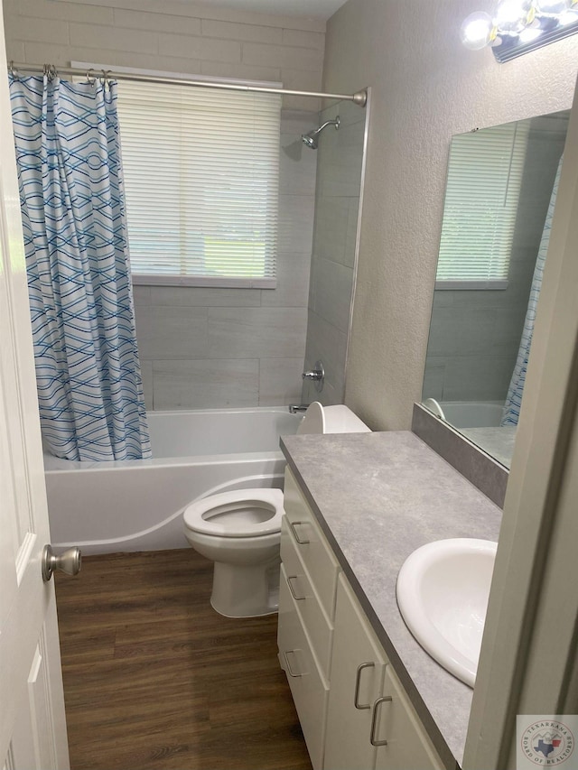 full bathroom with vanity, hardwood / wood-style flooring, a healthy amount of sunlight, and shower / bath combination with curtain