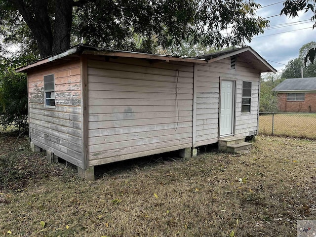 view of outbuilding with a yard