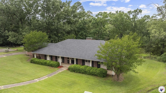803 Lakeridge Pl, Texarkana, TX 75503 - view of front of home with roof with shingles, brick siding, and a front lawn