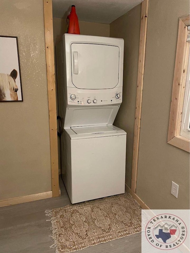 laundry room featuring stacked washer and clothes dryer