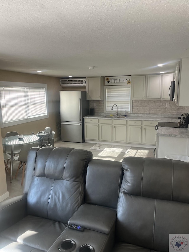 living room with sink and a textured ceiling